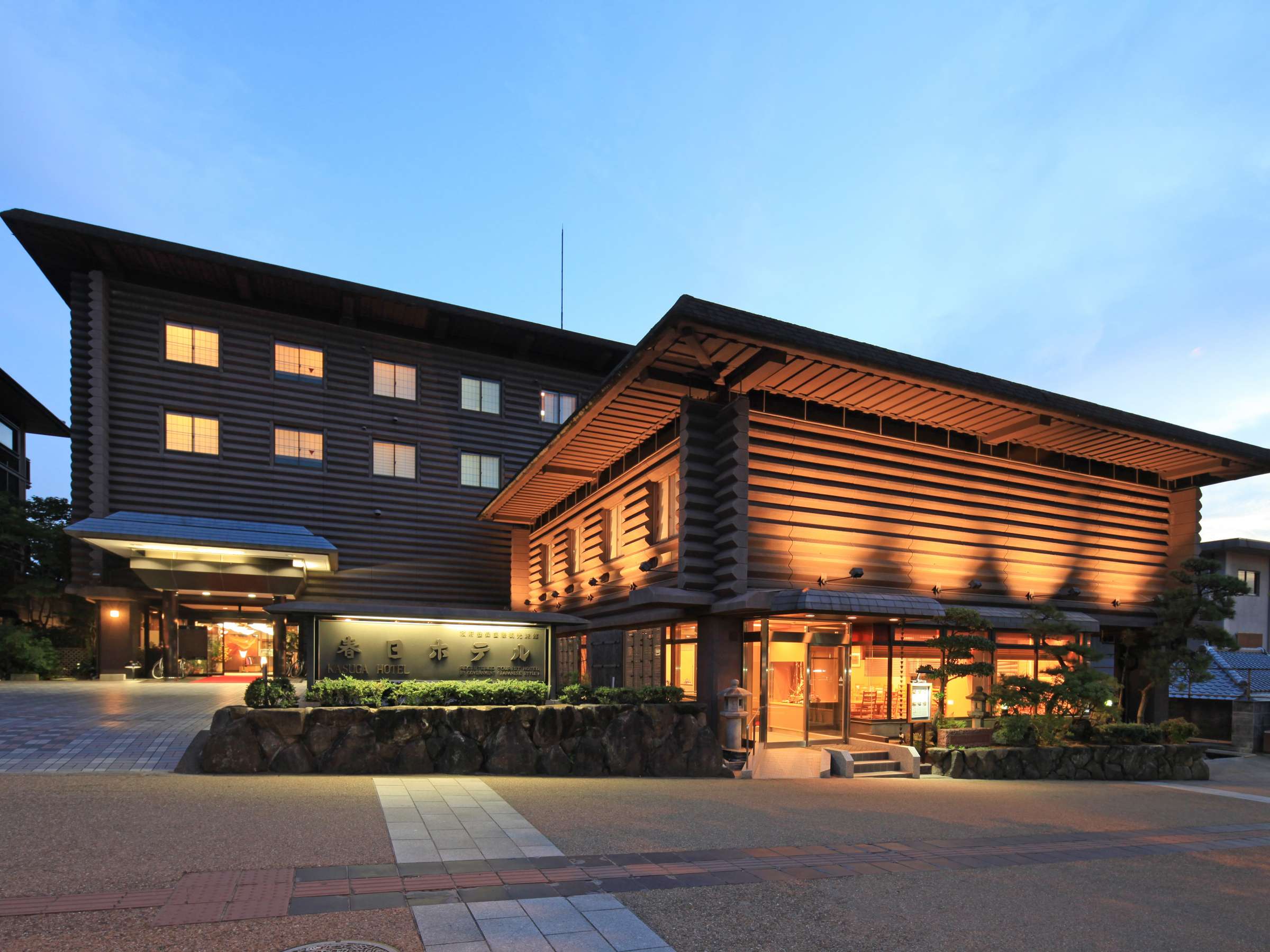 Kasuga Hotel wooden facade and entrance illuminated at dusk near Nara Park
