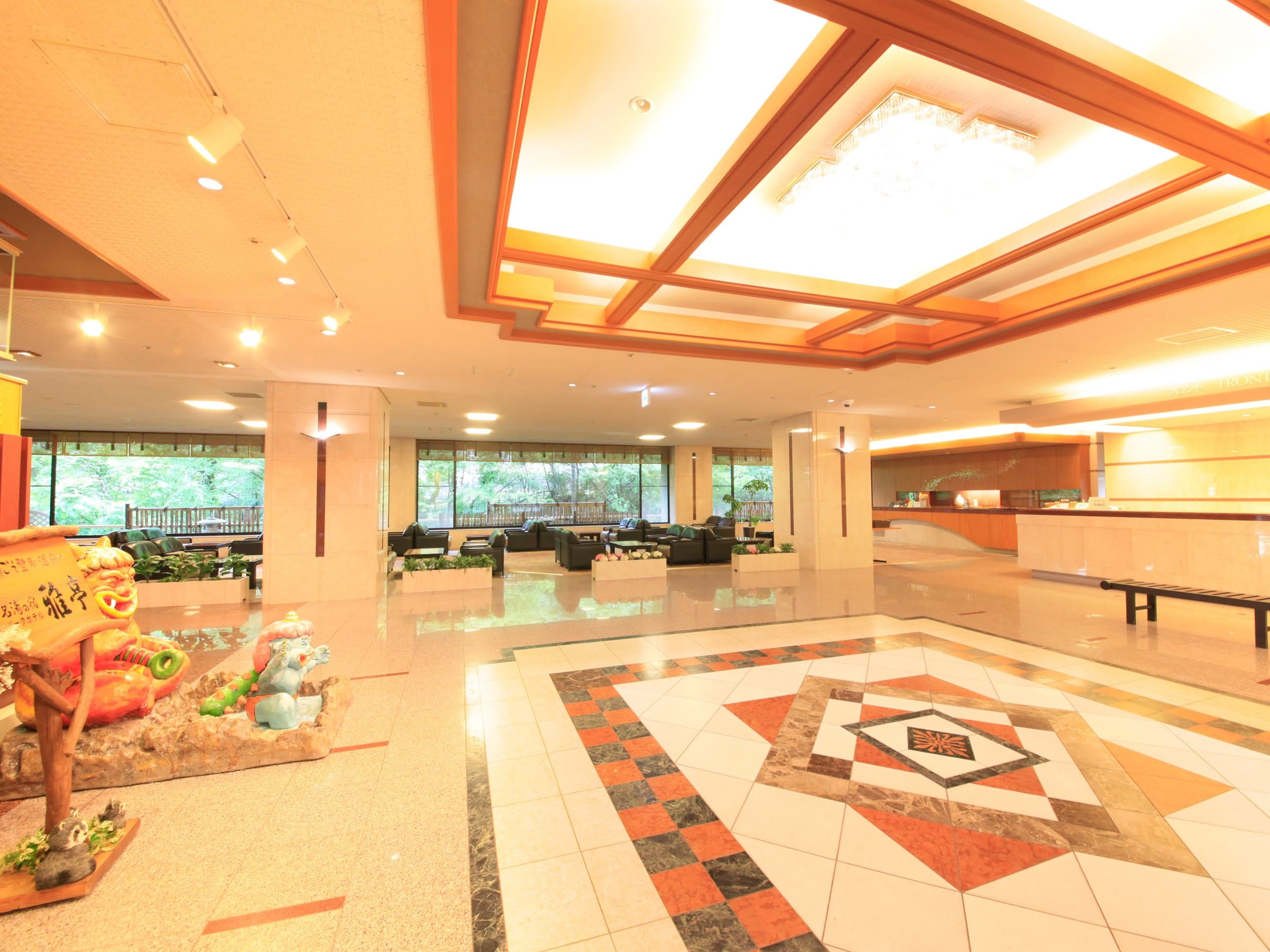 Spacious lobby with a patterned stone floor, lounge seating and a garden view at Park Hotel Miyabitei in Noboribetsu Onsen