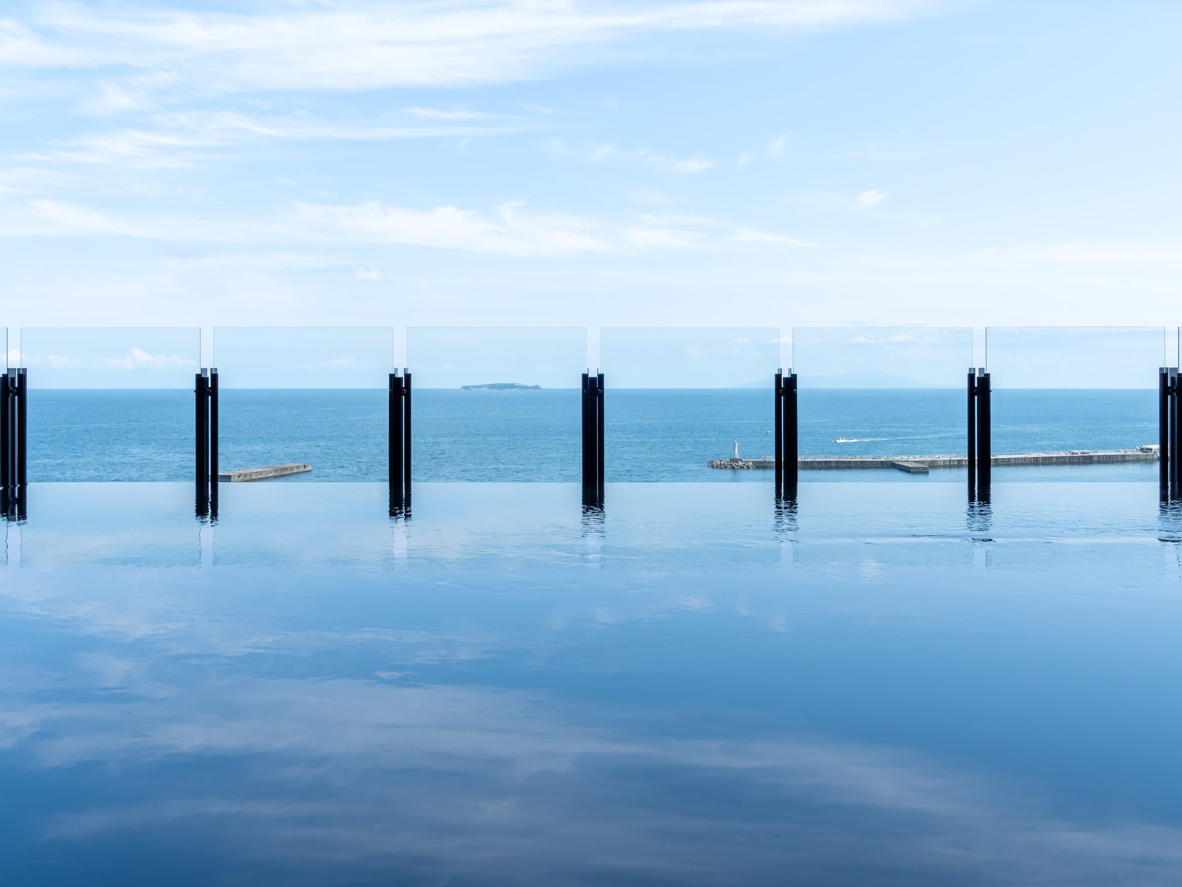 Rooftop infinity bath at Pearl Star Hotel Atami with water merging into Sagami Bay and offshore island view