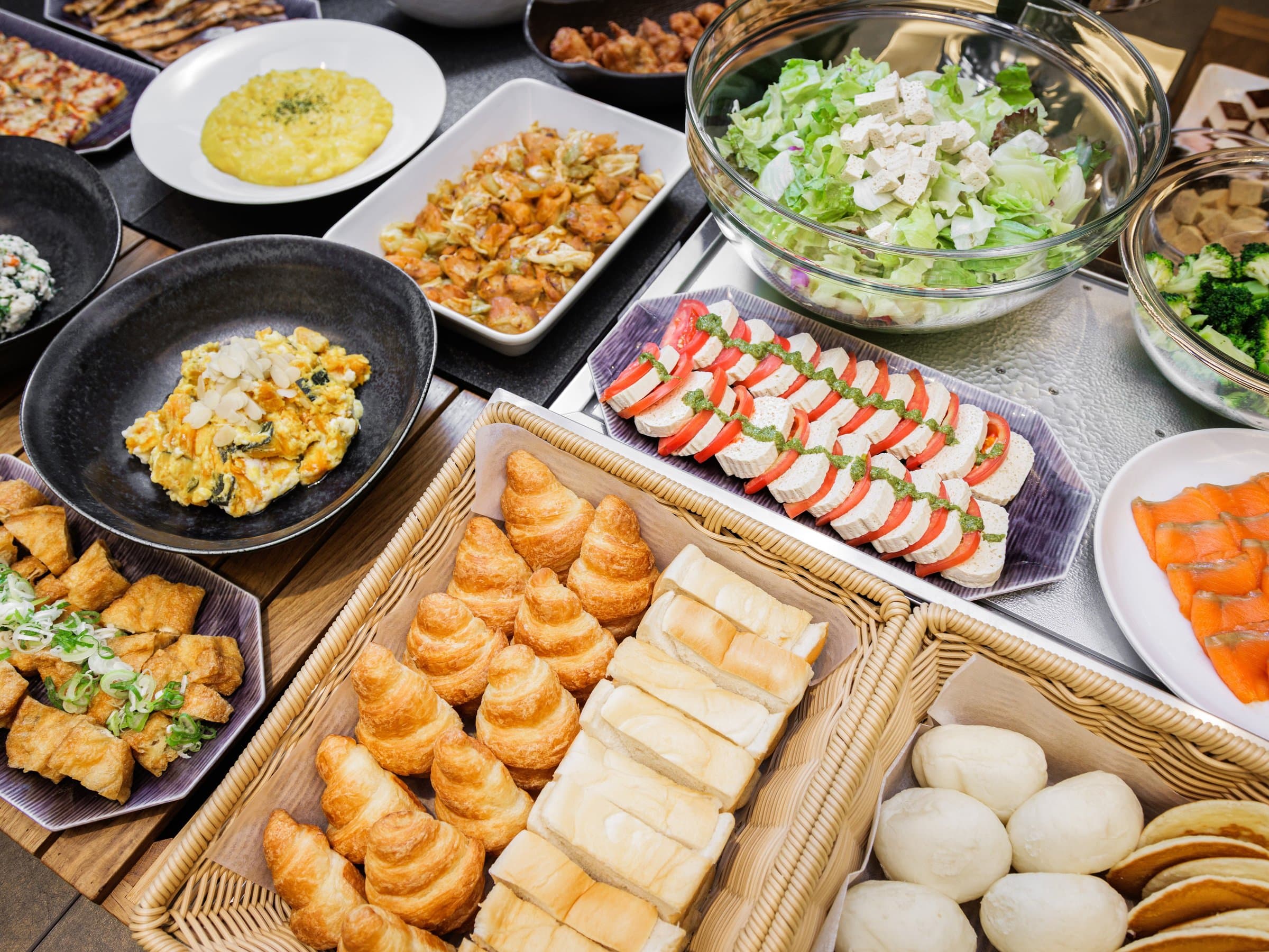 Breakfast buffet spread with croissants, salad, caprese and assorted side dishes