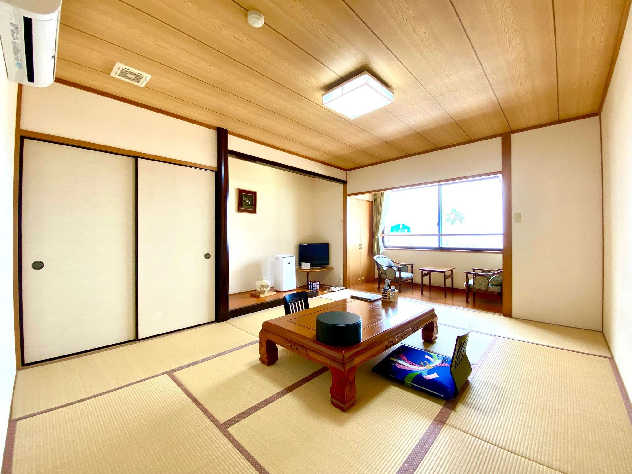 Spacious 10-tatami sea-facing guest room with low table at Ryokan Tsukimiso in Ibusuki Onsen
