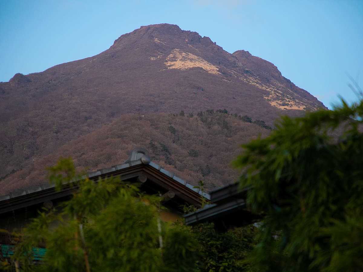 Mount Yufu rising above the ryokan roofline seen from Oyado Ichizen in Yufuin Onsen