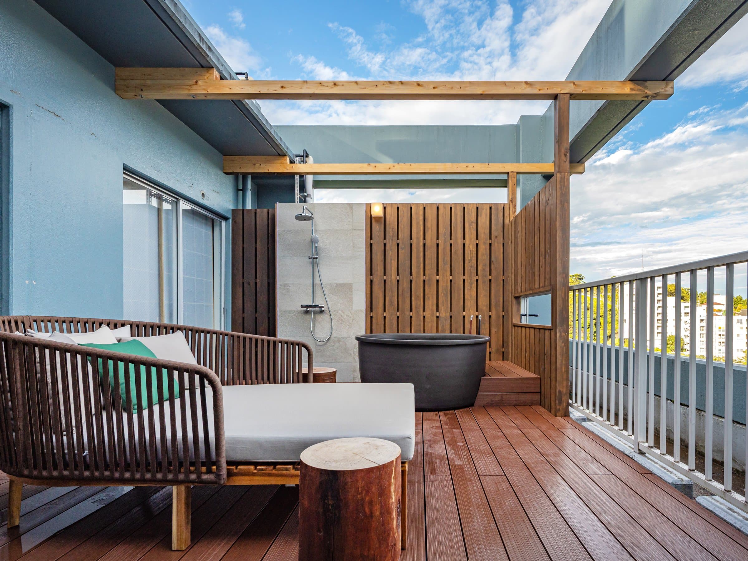 Rooftop terrace suite at ISHINOYA Atami with a private open-air cypress bath and wood deck under a blue sky
