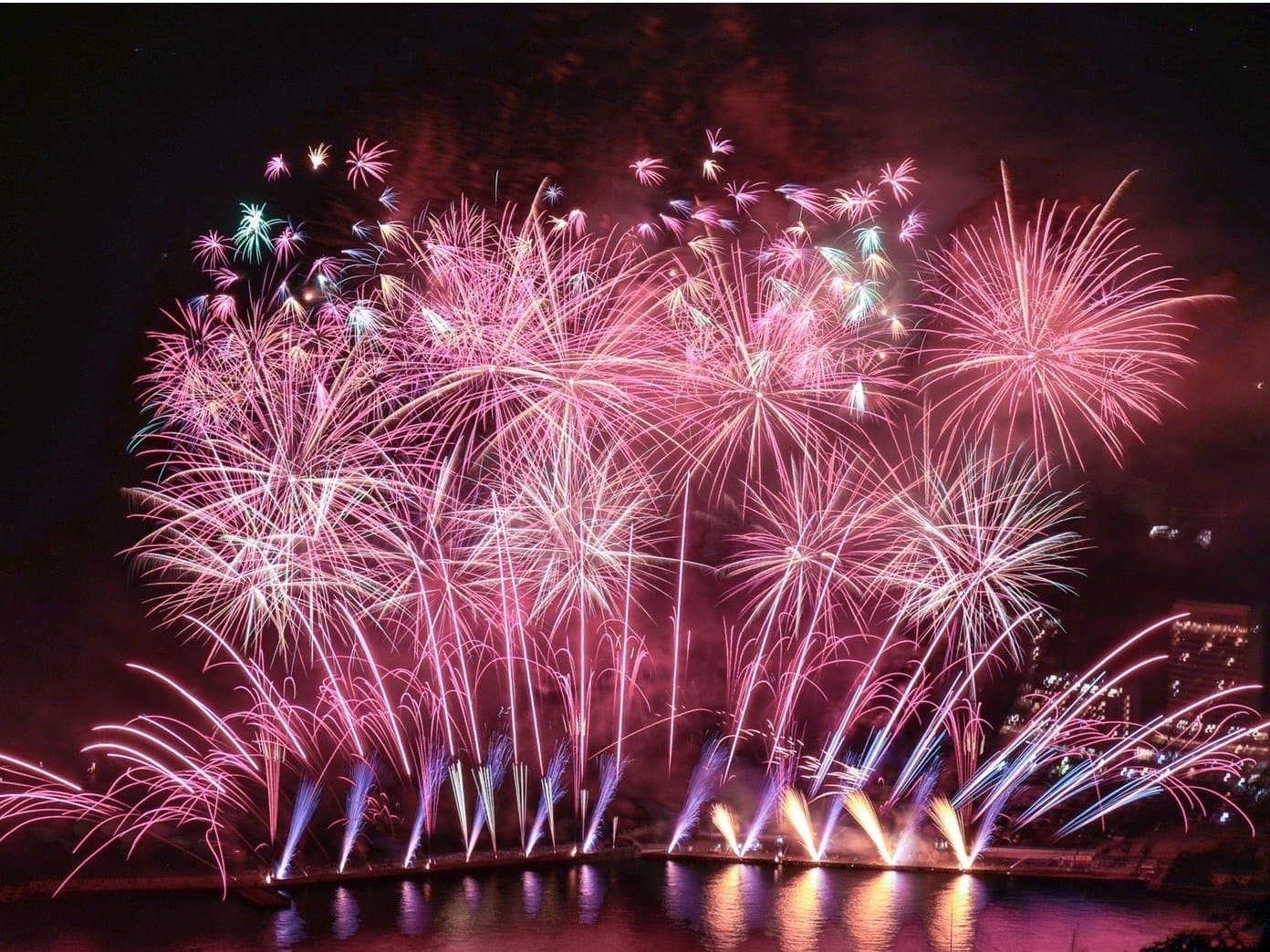 Summer fireworks bursting over Atami bay viewed from ISHINOYA Atami
