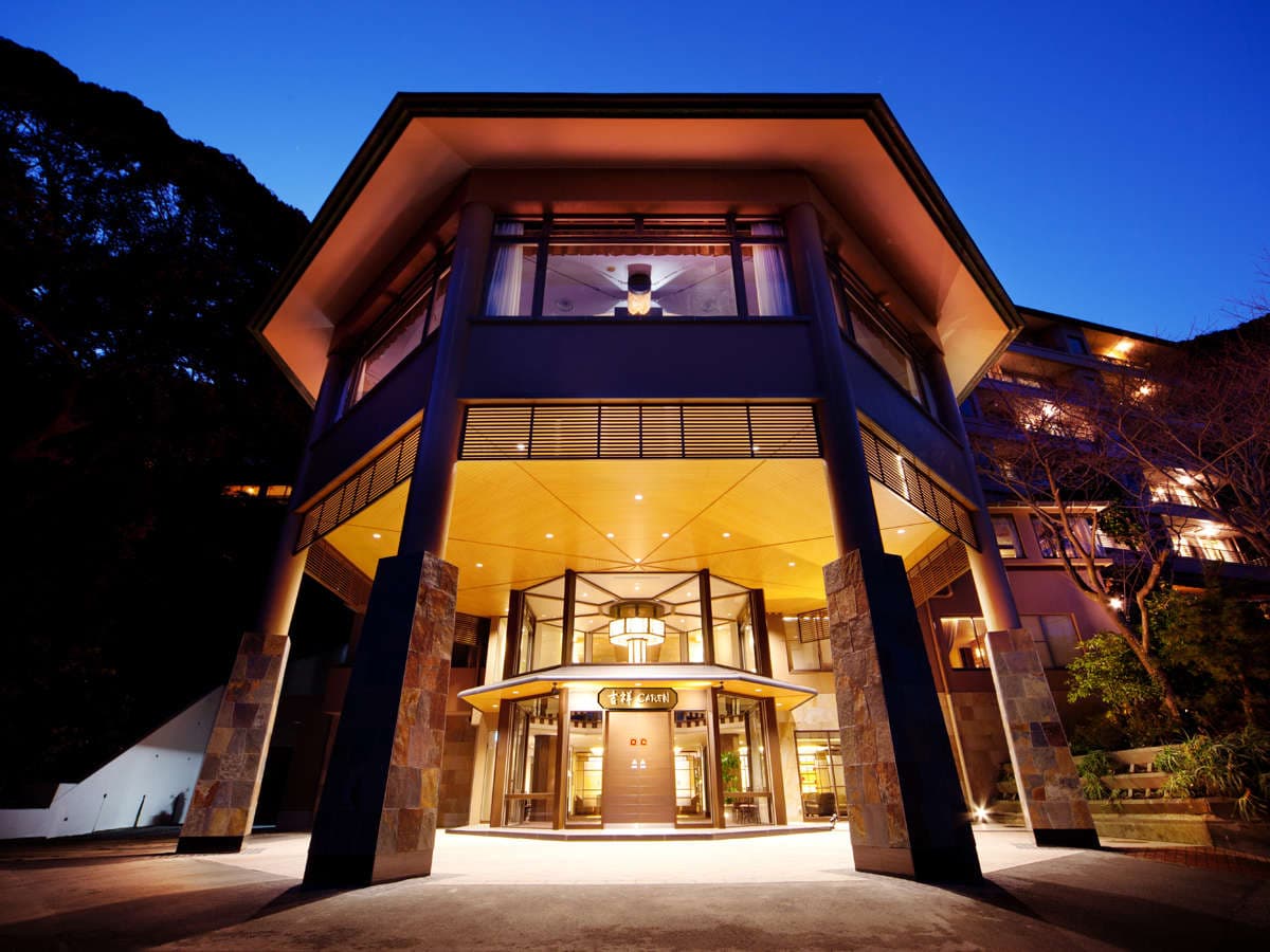 Illuminated main entrance and exterior of Kissho Caren at dusk in Izu Inatori