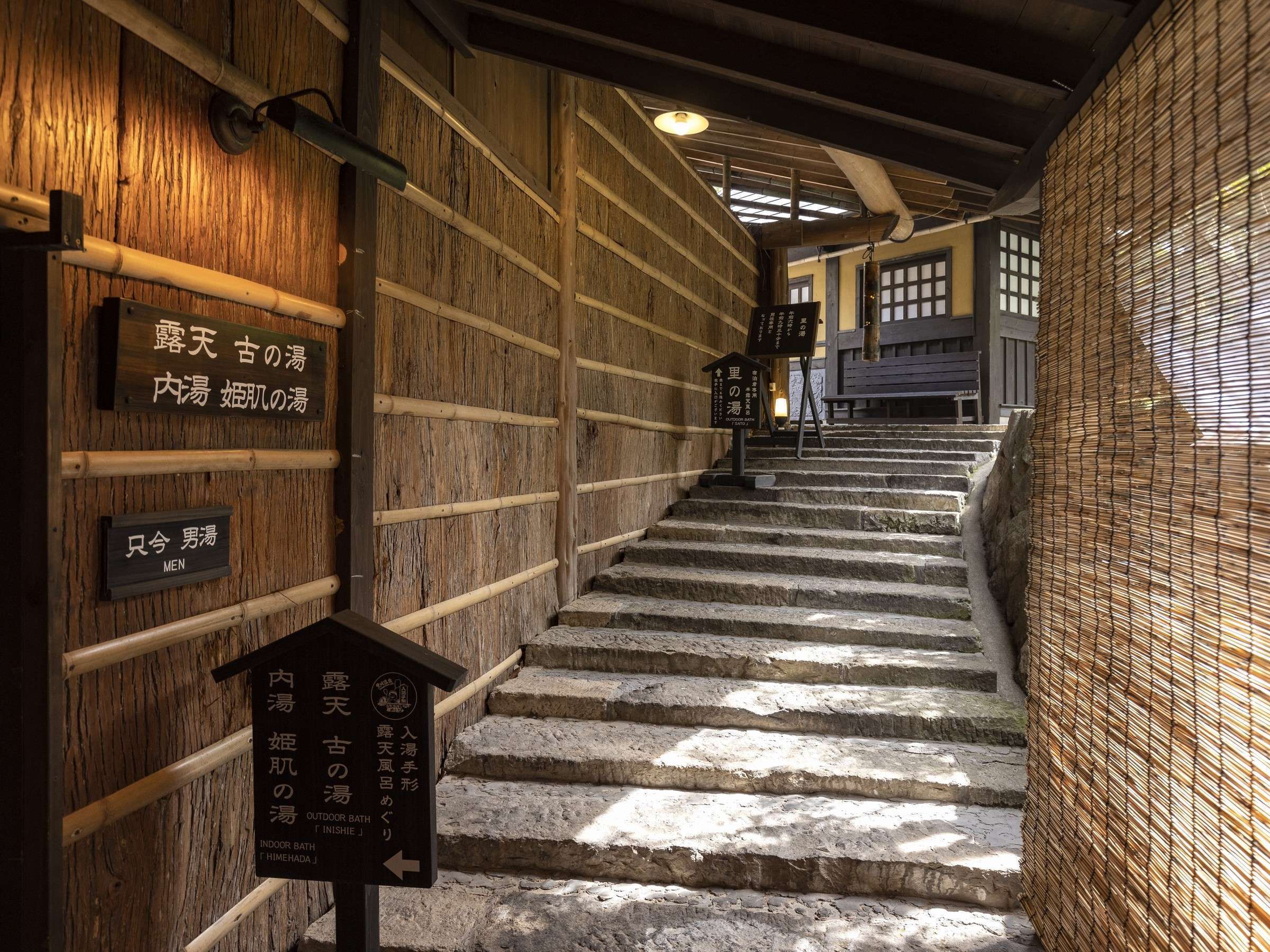 Okyakuya bamboo lantern and stone-paved approach path between the lodging and bath houses