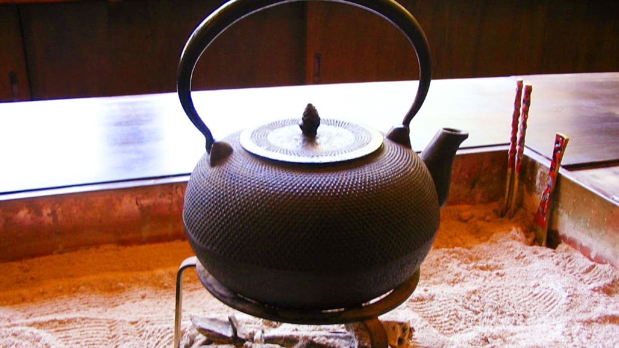 Cast-iron kettle over the sunken hearth