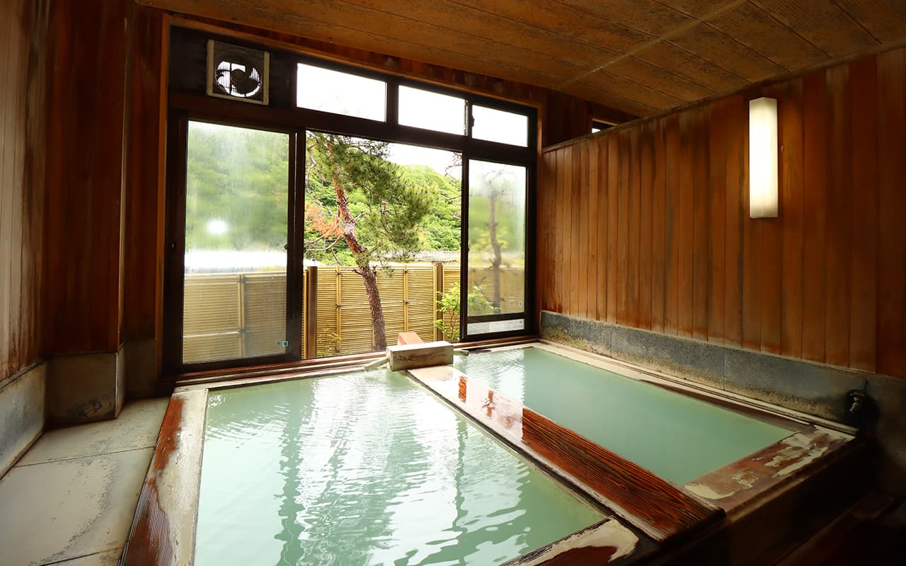 Cypress-wood indoor bath with milky white sulfur water and forest view