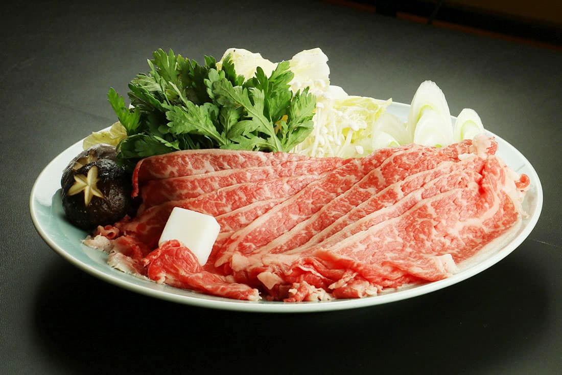 Plate of marbled Nasu wagyu beef with vegetables for sukiyaki