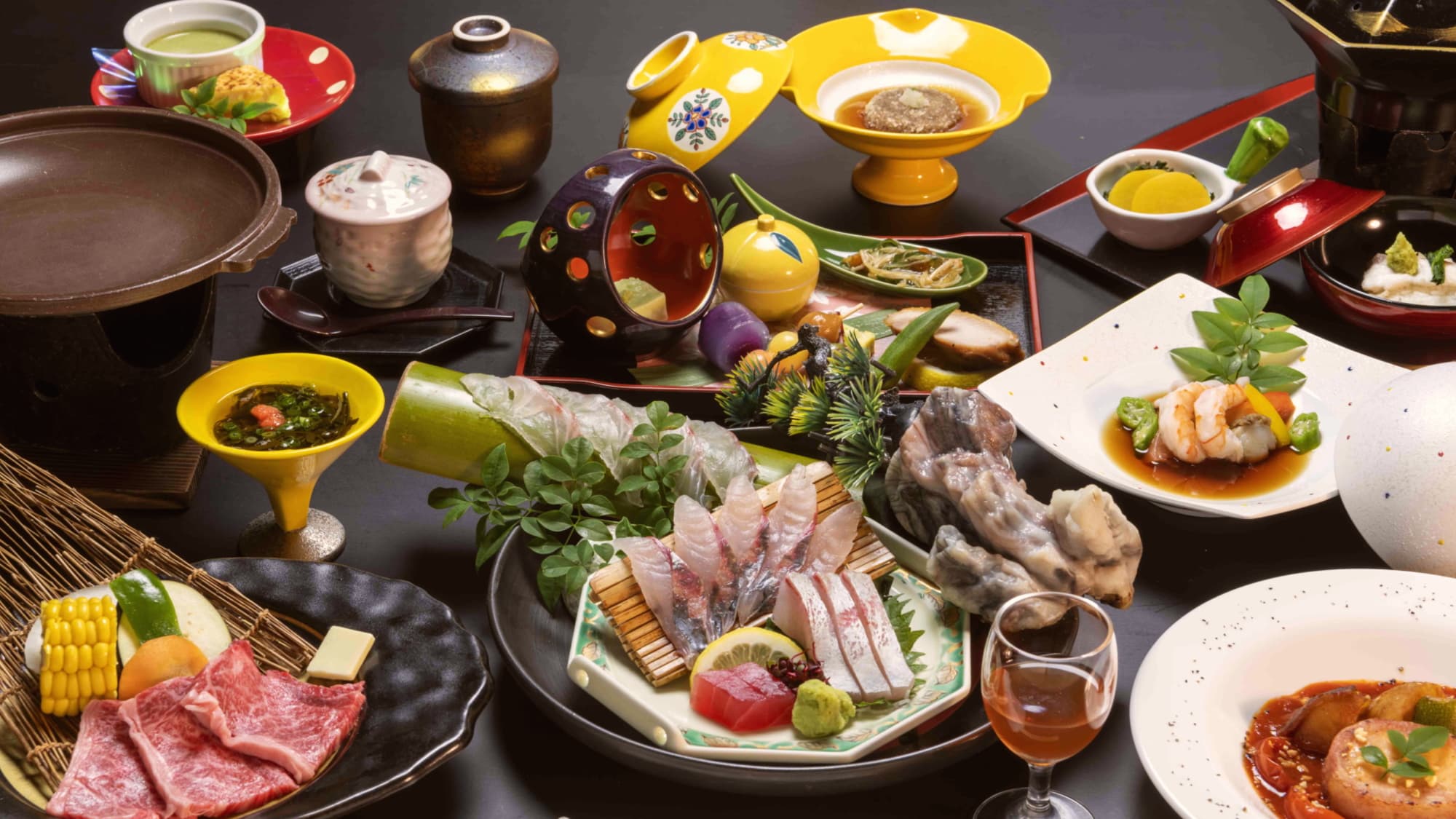 Multi-course kaiseki dinner spread with sashimi, wagyu beef, simmered dishes and colorful lacquerware, Hotel Sansuikan, Beppu Onsen