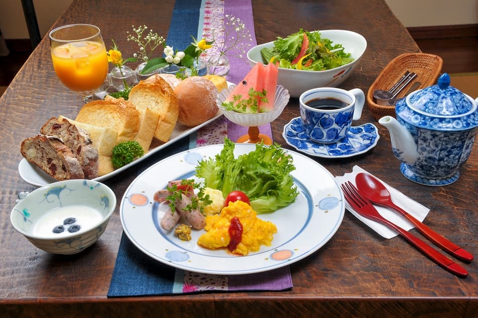 Breakfast spread with fresh bread, salad, yogurt and coffee
