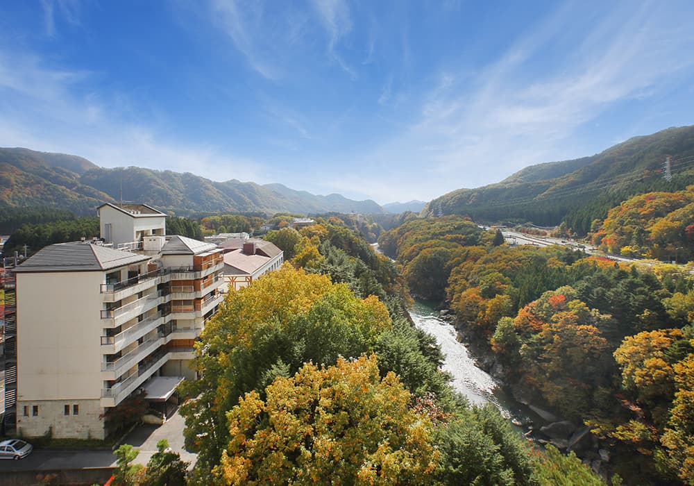 The ryokan building overlooking the Kinugawa gorge in autumn foliage