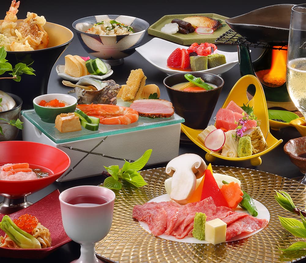 Multi-dish kaiseki dinner spread with sashimi, tempura and seasonal plates