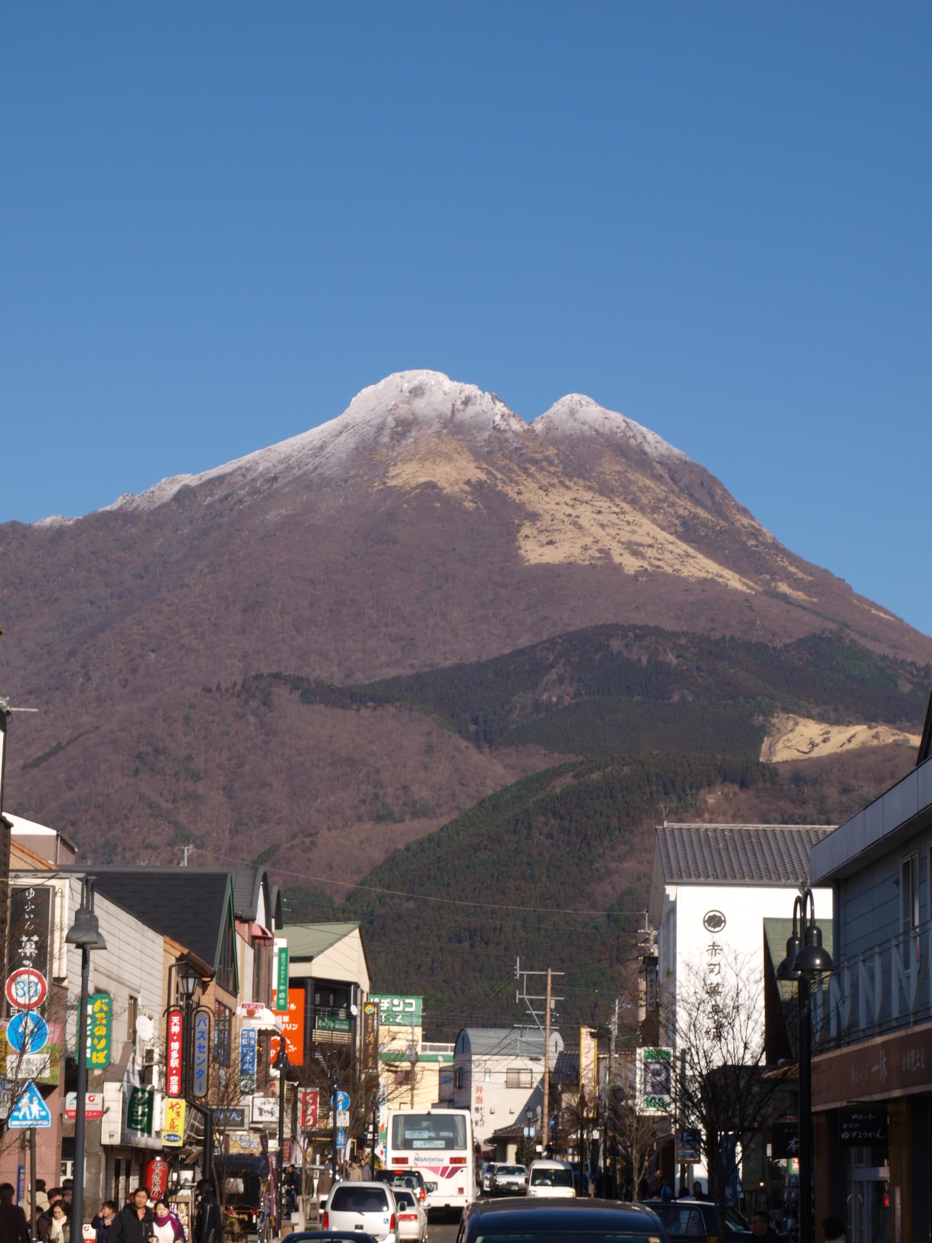 Yufuin onsen town with Mount Yufu rising behind — the Kyushu hot-spring village featured in the couples ryokan picks.
