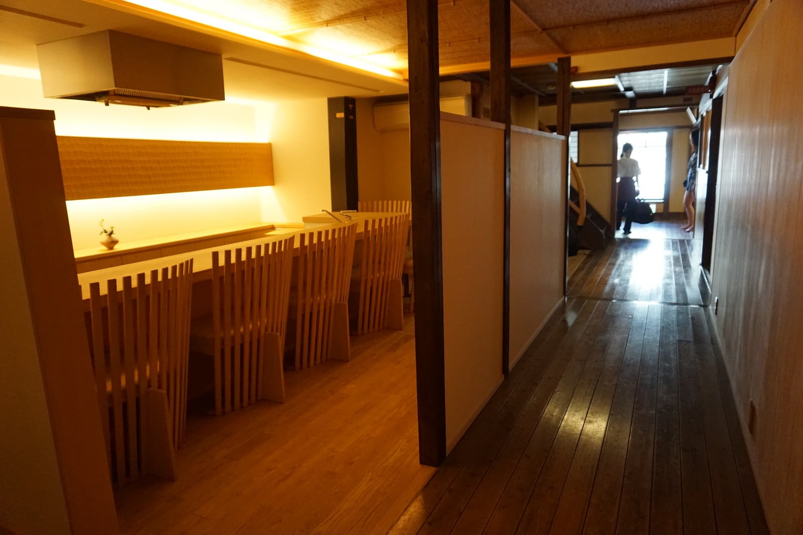 Traditional ryokan interior hallway with tatami flooring and shoji screens — the architectural setting that defines the honeymoon ryokan experience.