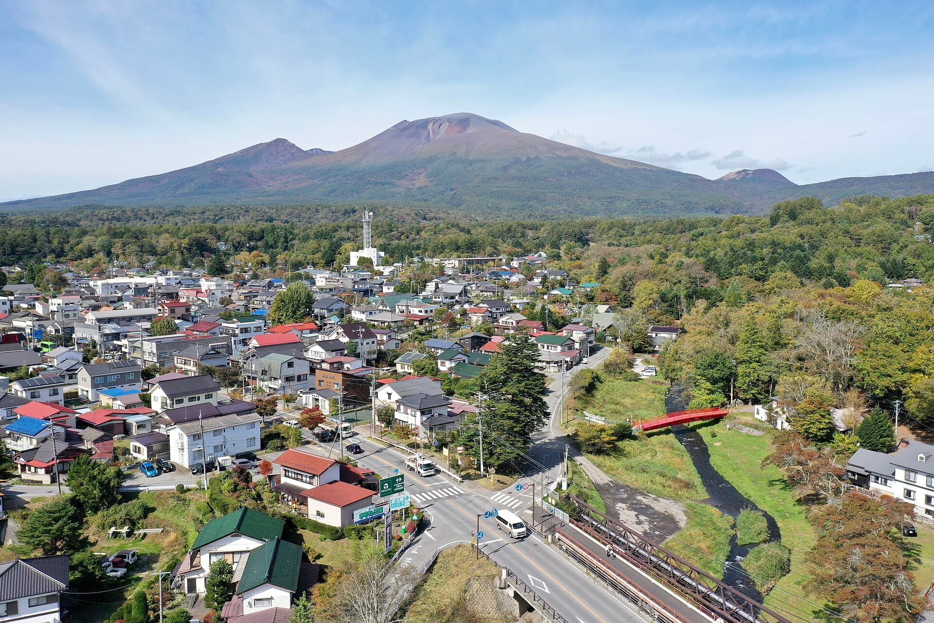 Mt. Asama and Karuizawa highlands with forested foothills under a blue sky