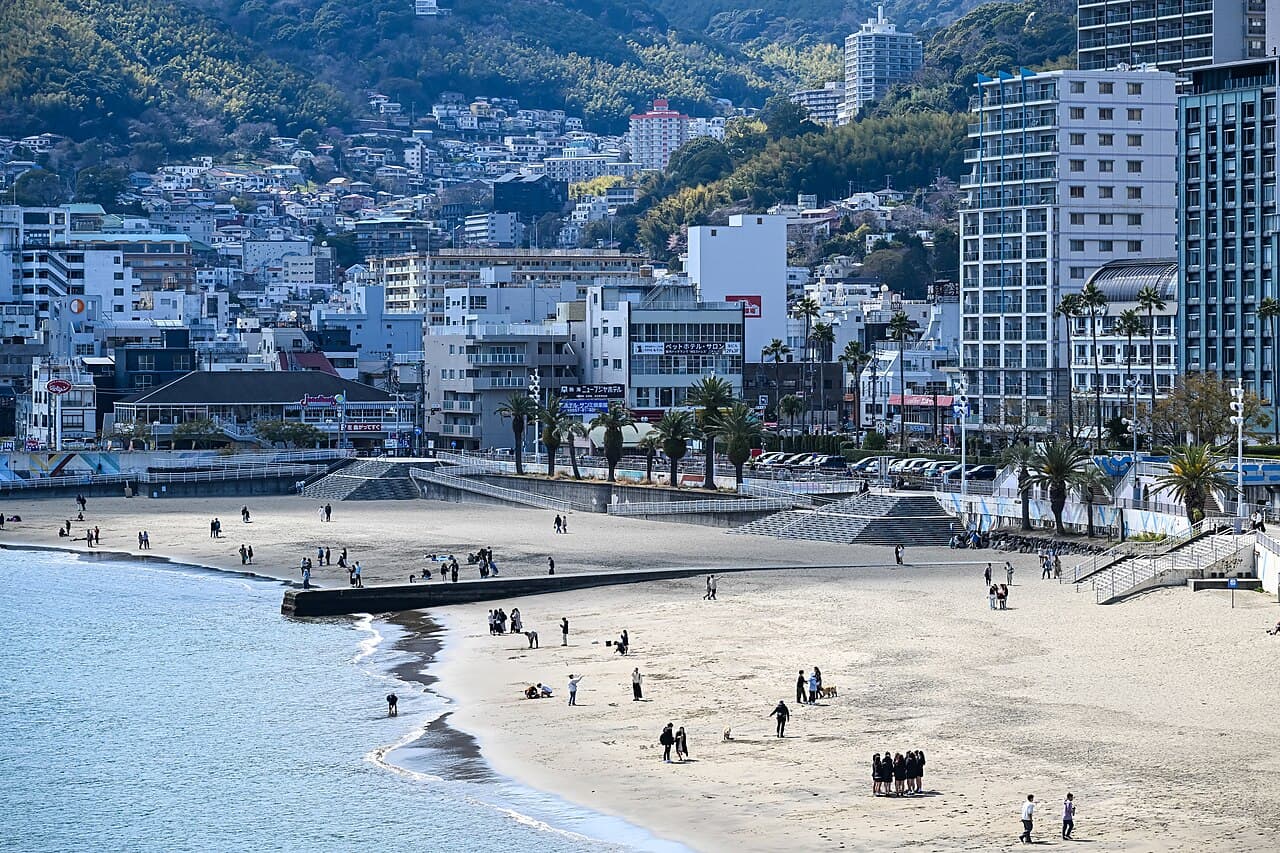 Atami Sun Beach coastal view with sandy shore, Pacific Ocean, and distant headlands