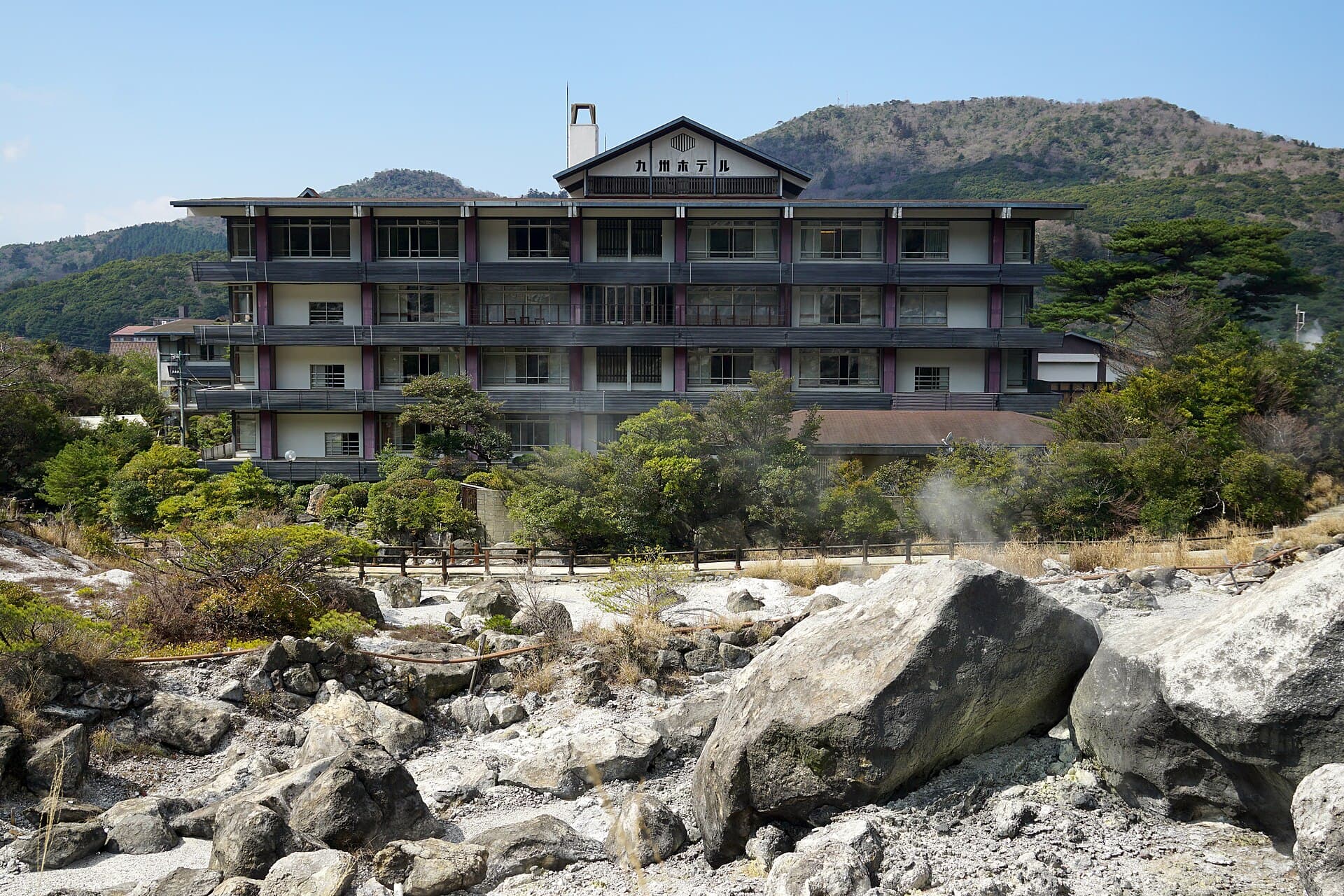 Steam rising from the sulphur-yellowed rocks and hot spring pools of Unzen Jigoku (Unzen Hells) in Nagasaki, Japan.