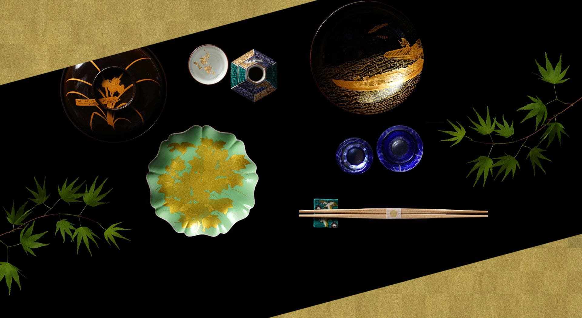 Kanazawa lacquerware and Kutani sake cups arranged on gold leaf with maple leaves, signature tableware at Kanazawa Chaya