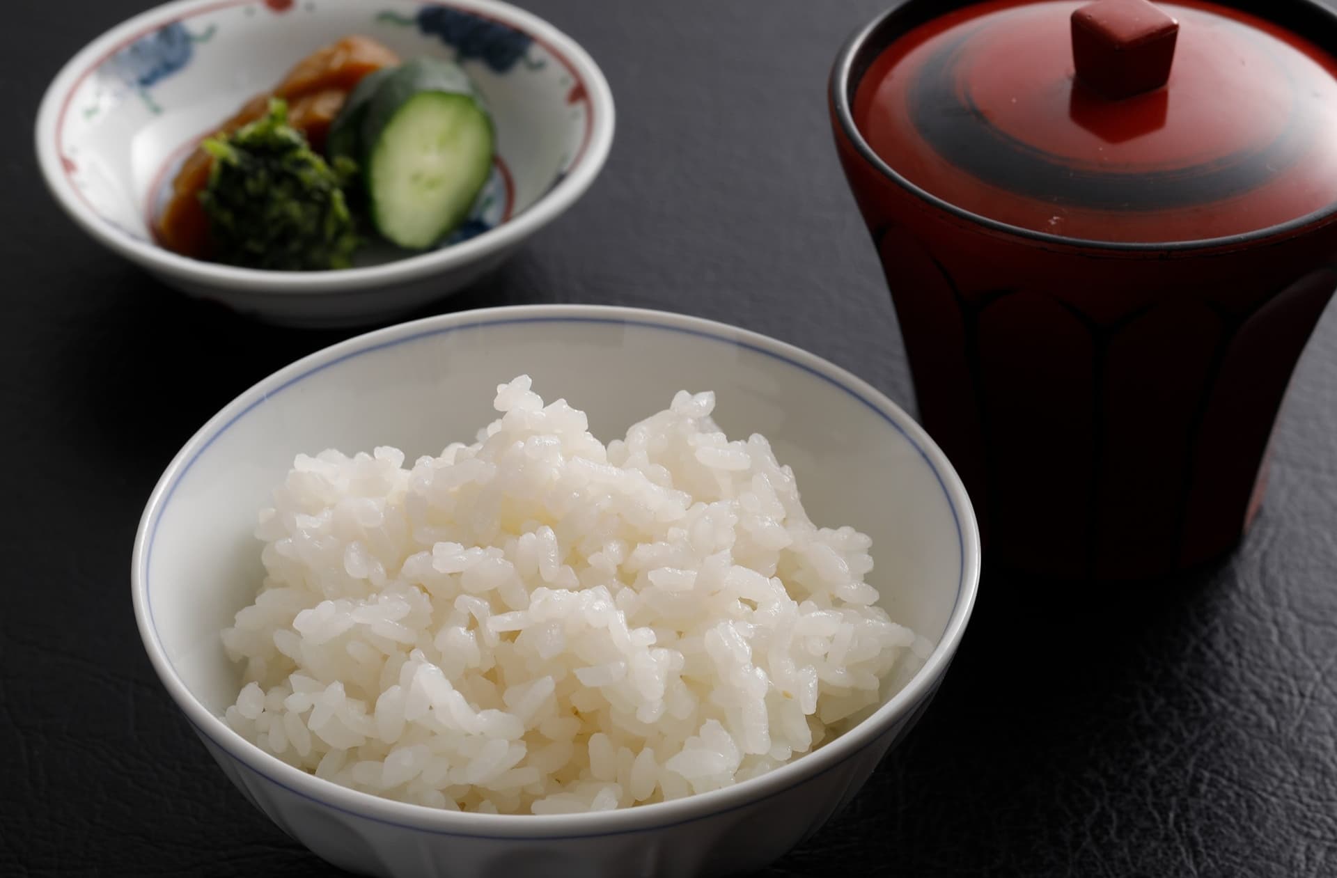 Hot-pot course of leafy vegetables, enoki mushrooms and tofu in patterned bowls at Miyukiso Hanamusubi