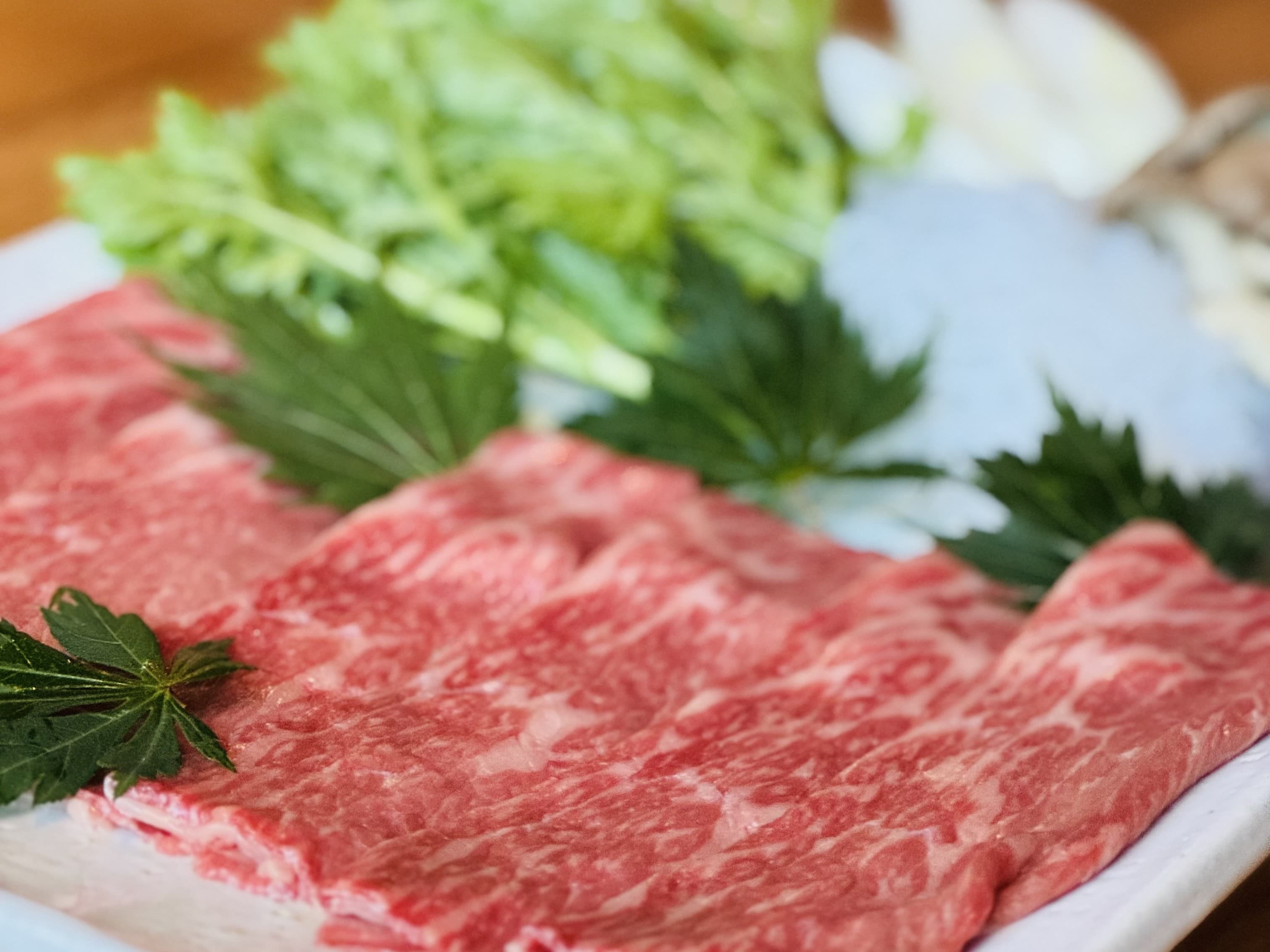 Marbled wagyu beef platter with fresh greens served for shabu-shabu at Matsunoki-tei