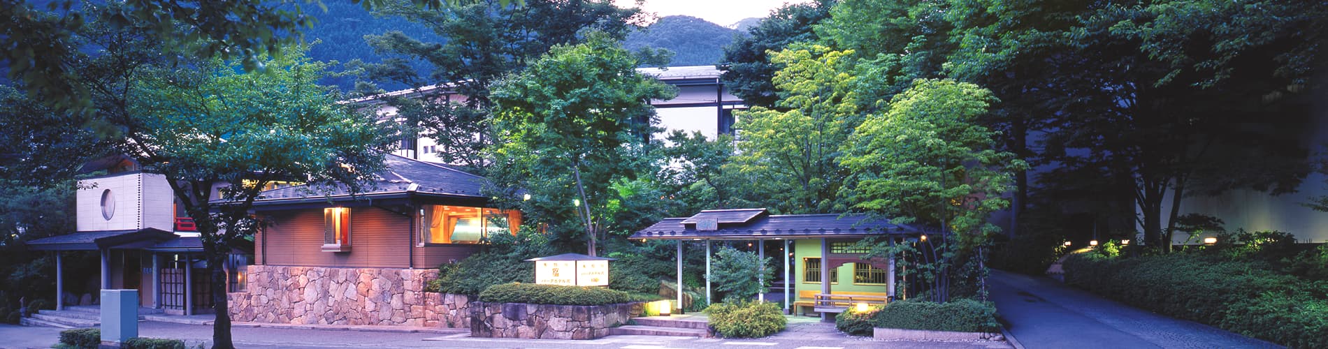 Kinugawa Park Hotels main building and landscaped entrance garden lit at dusk in Kinugawa Onsen, Nikko