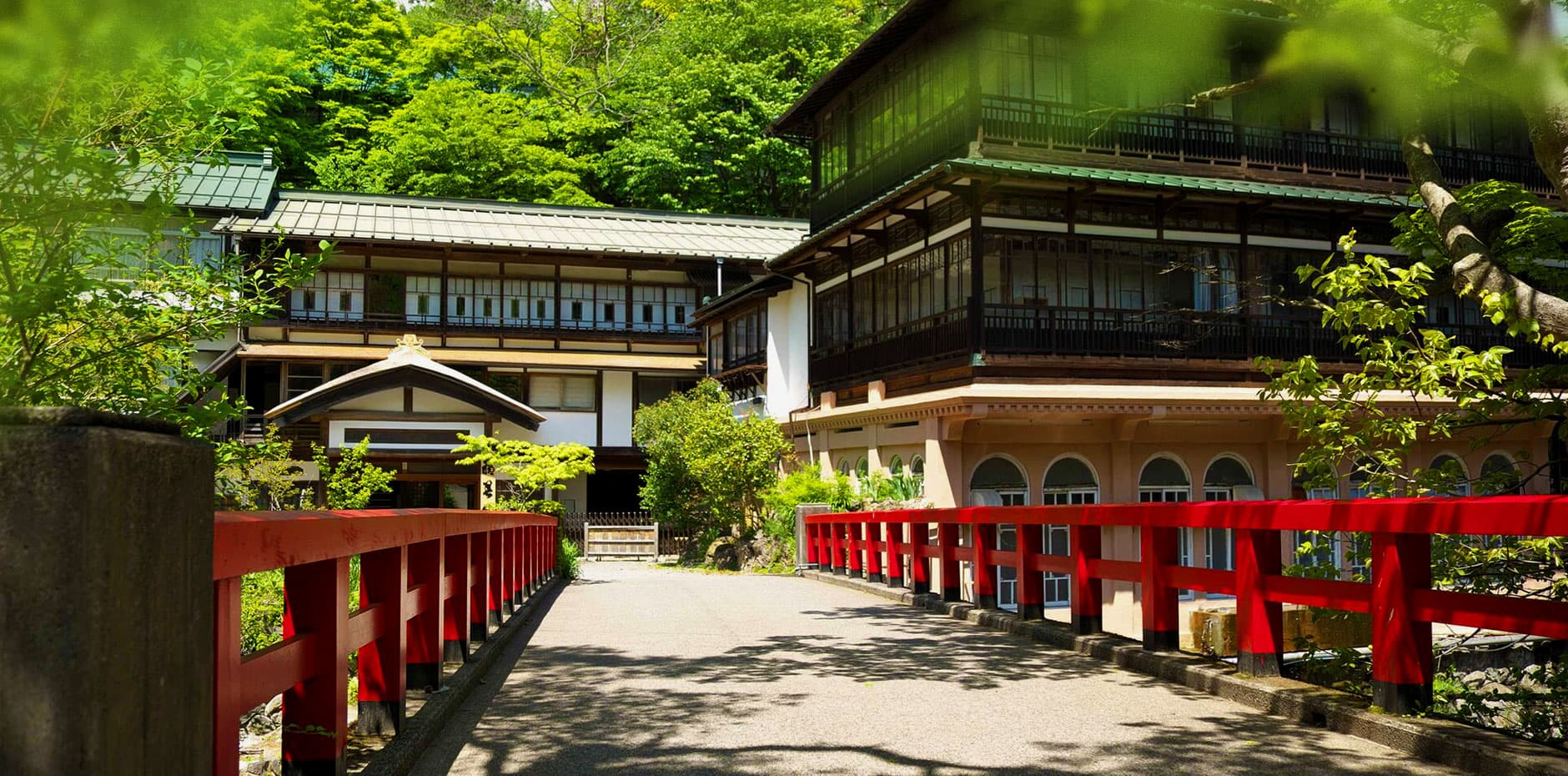積善館 朱塗りの慶雲橋と本館外観(千と千尋の湯屋のモデル) © sekizenkan.co.jp