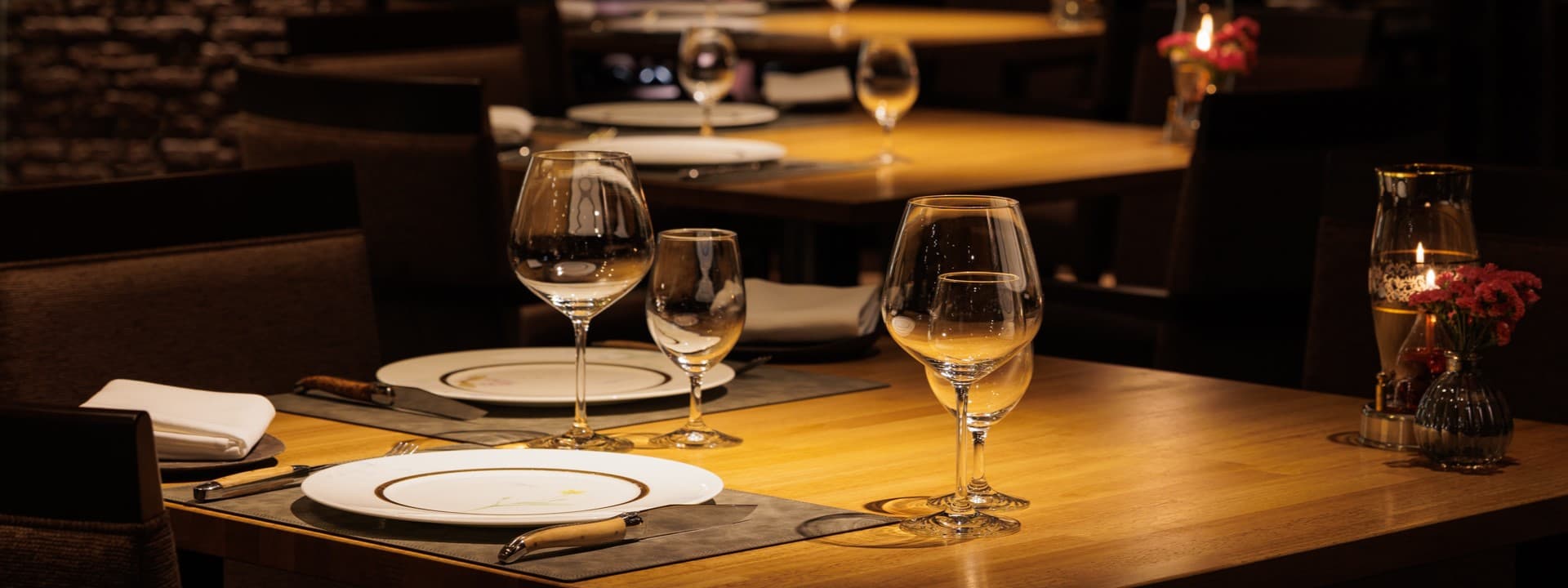 Elegant candlelit dinner table setting with wine glasses at the Chamonix dining room of Hakuba Tokyu Hotel